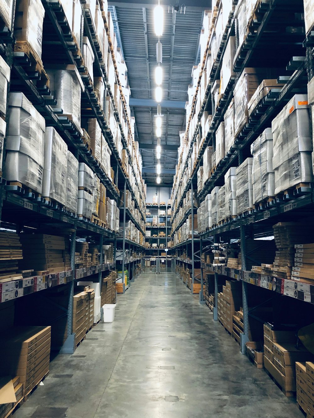 Modern warehouse aisle stocked with shelved goods